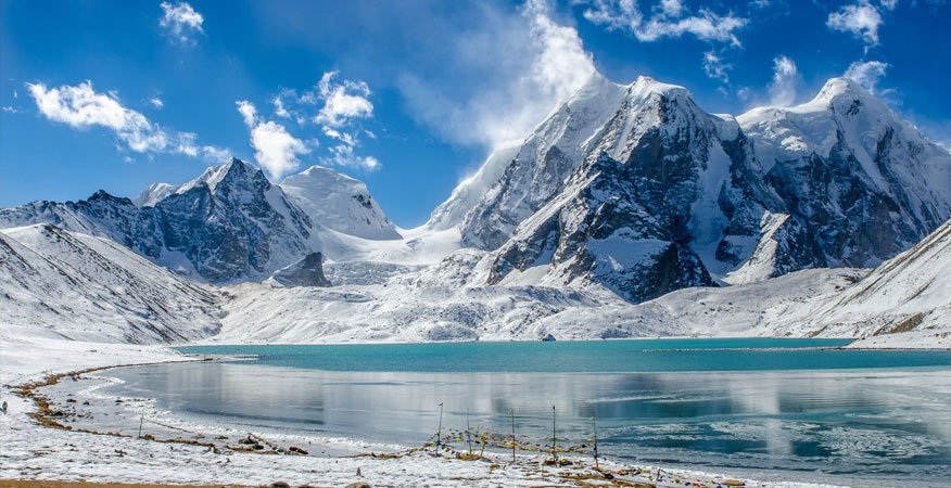 A premium heavy-duty SUV taxi navigating the high-altitude terrain near Gurudongmar Lake in North Sikkim
